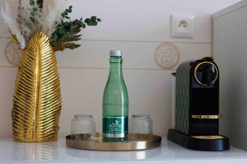 a bottle of wine sitting on a counter next to a blender at Villa Mala Praha Experience in the Center of Žilina in Žilina
