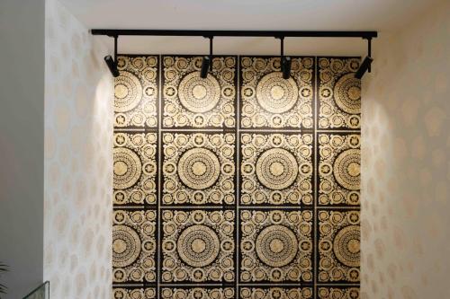 a metal door with a curtain on a wall at Villa Mala Praha Experience in the Center of Žilina in Žilina