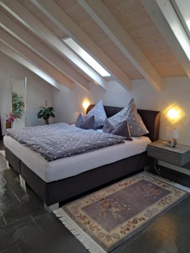a bedroom with a large bed with blue pillows at Ferienwohnung Henry im schönen Allgäu in Westendorf