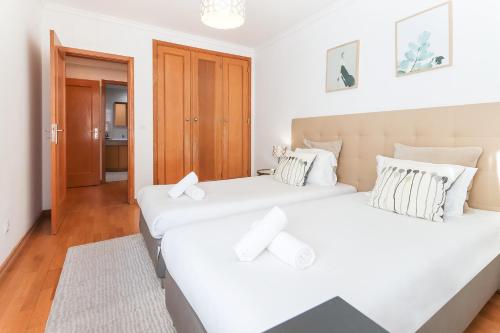 Ce lit se trouve dans un dortoir doté de murs blancs et de parquet. dans l'établissement Laranjeiras Design by Homing, à Lisbonne