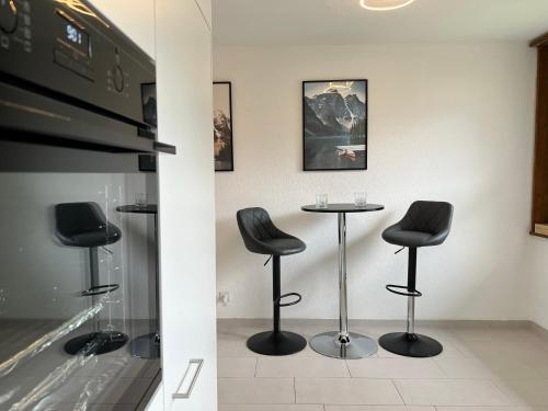 a kitchen with a table and chairs and a stove at Breathtaking Waterfall Apartment nr.2 in Lauterbrunnen