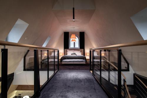a attic bedroom with a bed and a window at LES GITES DE LA KARLSMUHLE in Haguenau