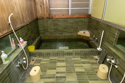 a bathroom with two toilets and a tiled floor at オーベルジュ樹氷 in Yamagata