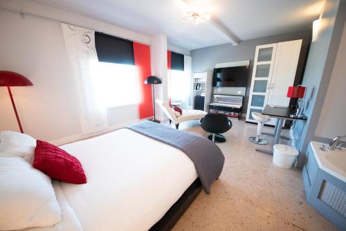a bedroom with a large white bed and a desk at Days Inn by Wyndham Berthierville in Berthierville