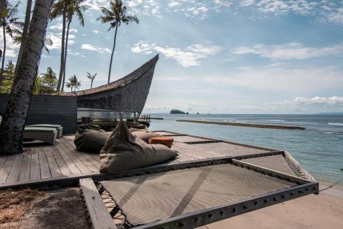 a resort patio with a view of the ocean at Villa Manis Beachfront Candidasa in Candidasa