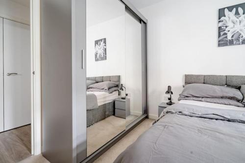 a bedroom with a mirror and a bed in it at Charming room in the Heart of London in London