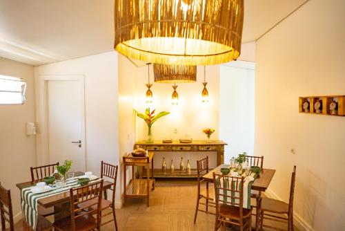 a dining room with a table and a chandelier at Pousada da Villa in Fernando de Noronha