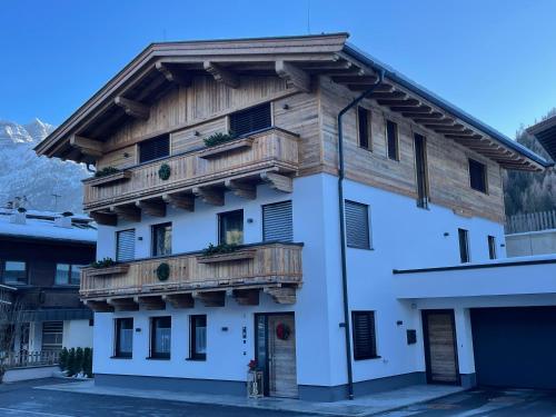 a white building with wooden balconies on it at Haus Lackner in Waidring