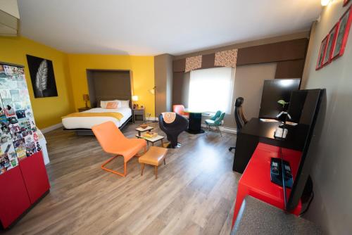 a hotel room with a bed and a living room at Days Inn by Wyndham Berthierville in Berthierville