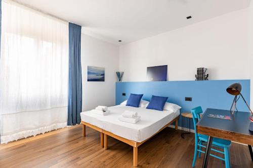 a bedroom with a bed and a blue wall at Casa Peppino Verona in Verona