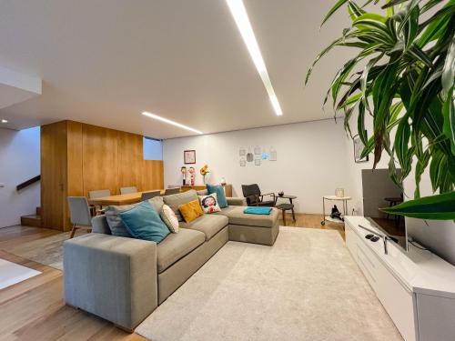 a living room with a couch and a table at Casa do Trigo - with garage in the city center in Viana do Castelo