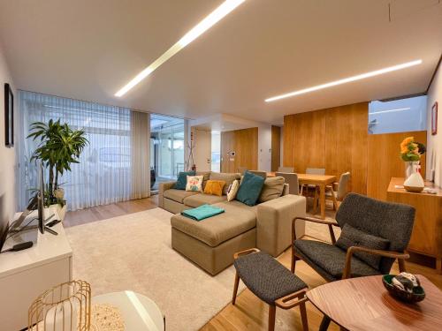 a living room with a couch and a table at Casa do Trigo - with garage in the city center in Viana do Castelo