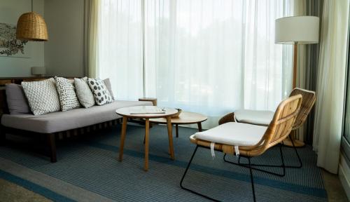 a living room with a couch and a table and chairs at Casagrande Hotel & Beach Club in José Ignacio