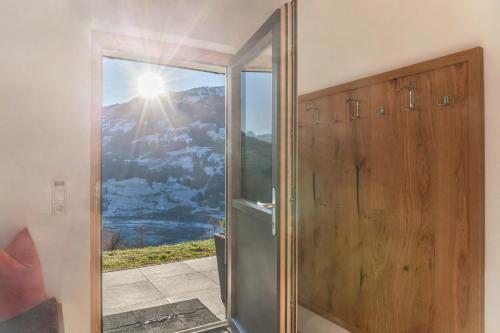 a glass shower door with a view of a mountain at Apartment Bergglück Stummerberg in Stummerberg