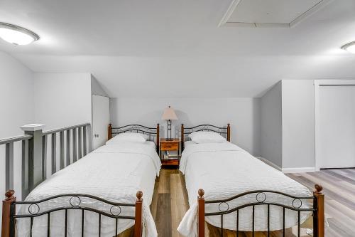 two beds in a room with white walls at Updated Minersville Townhome by ATV Trail! in Mount Pleasant