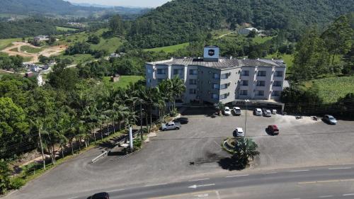 an aerial view of a building with a parking lot at Real NOB Hotel in Orleans