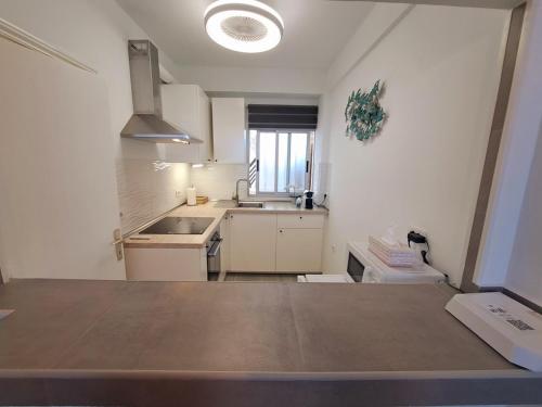 a kitchen with a sink and a counter top at Ocean View Penthouse in Playa de las Americas