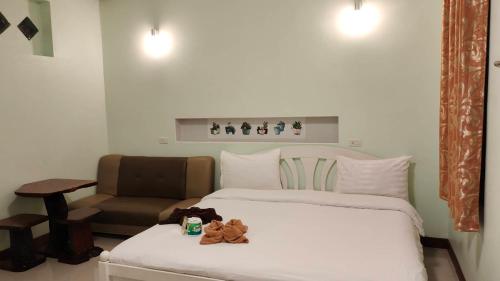 una habitación de hotel con 2 camas y una silla en Lee-view Wangnamkeaw, en Wang Nam Khiao
