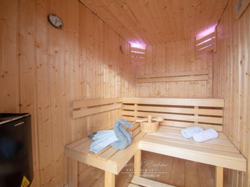 a wooden sauna with two towels and two towels at Houseboat Seahorse in Heiligenhafen