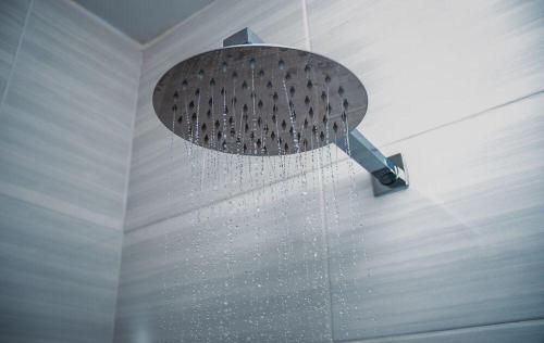 a shower in a room with a shower head at Conmilla Guest House and Conference Venue in Berea Hills