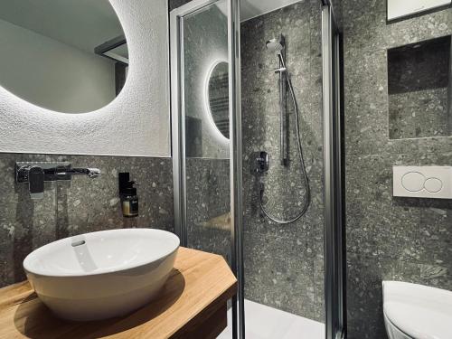 a bathroom with a white sink and a shower at Untergrundgut in Leogang