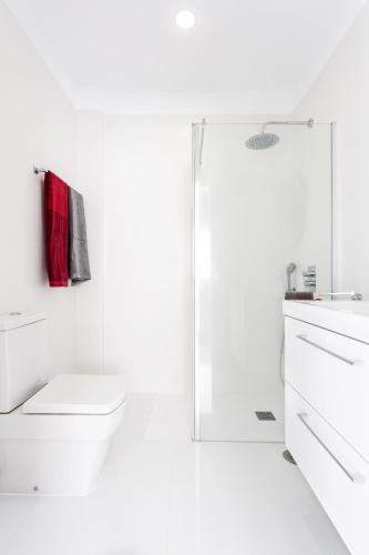 a white bathroom with a toilet and a shower at Estefania in Chayofa