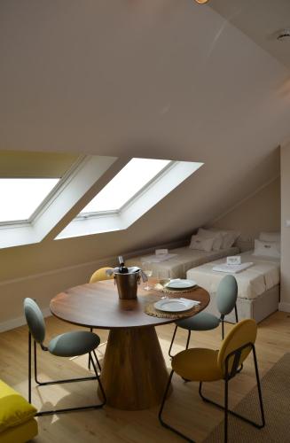 a dining room with a table and skylights at Casa do Theatro Guest House in Barcelos