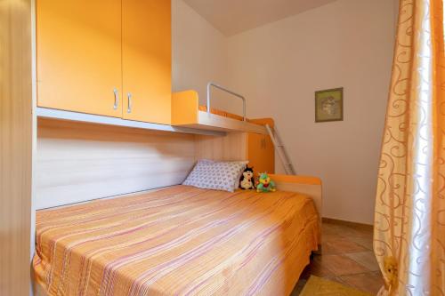 a bedroom with a bed and a bunk bed at Casa Michela in Viddalba