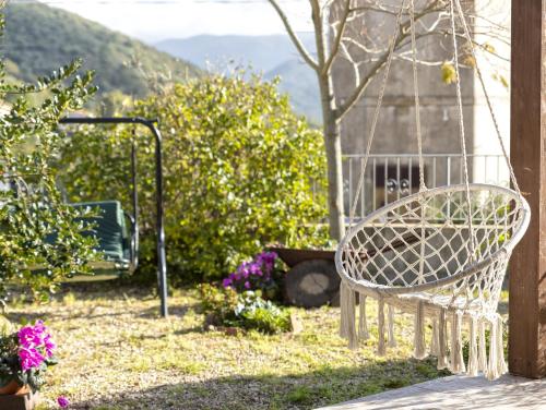 a white chair sitting on a porch with flowers at Casa Michela in Viddalba