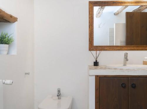 a bathroom with a sink and a mirror at Villa Can Truy in Sant Josep