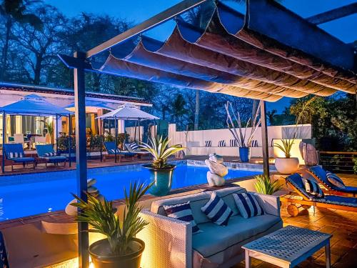 a patio with a couch and a swimming pool at Boutique Beachfront Hotel on Isla Contadora in Contadora
