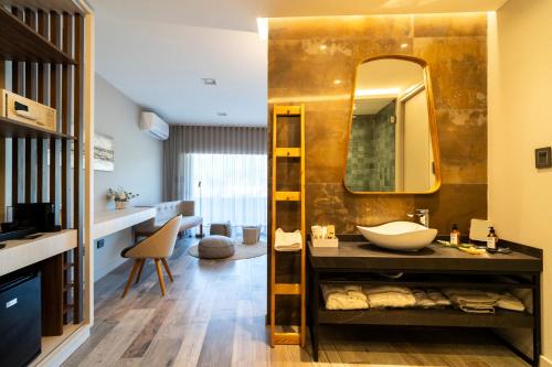 a bathroom with a sink and a mirror at Domingo Design Hotel in Santa Rosa de Calamuchita