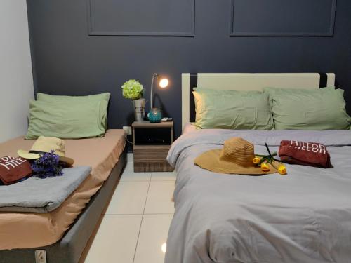 two beds with hats on them in a bedroom at Arte Mont Kiara KLCC Changkat Bukit Bintang Publika 4 Pax Jalan Alor Pavilion 1R2B in Kuala Lumpur