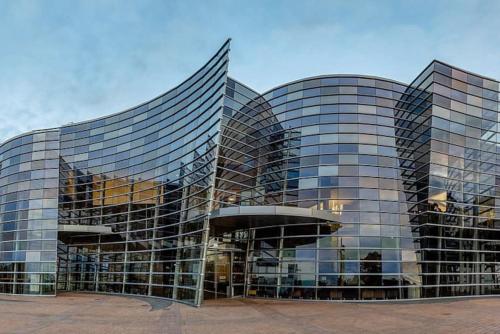 a large glass building with a lot of windows at Cute on Cashel 1 in Christchurch