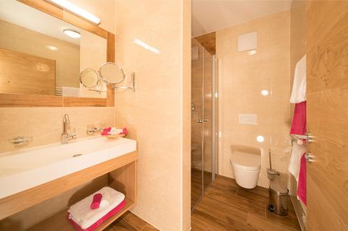 a bathroom with a sink and a shower and a toilet at Landhaus Lexner in Tux