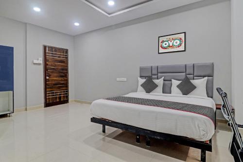 a bedroom with a large bed and a flat screen tv at Collection O Hotel Lavish Springs in Hyderabad