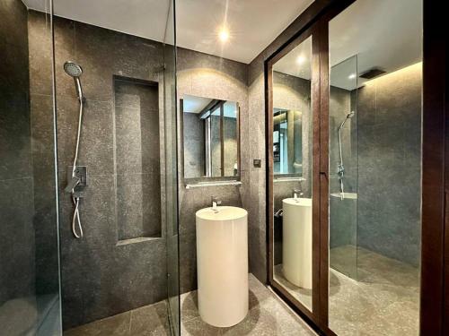 a bathroom with two sinks and a glass shower at Kamala poolview 2 bedroom suite in Kamala Beach