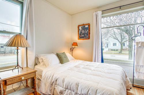 een slaapkamer met een bed en een groot raam bij Lovely Elkhart Lake Apartment - Walk to Town! in Elkhart Lake