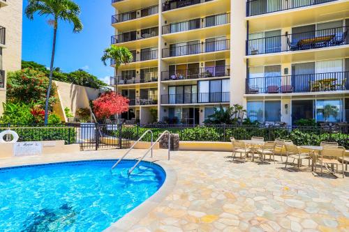 a swimming pool in front of a apartment building at Hololani Resort in Kahana
