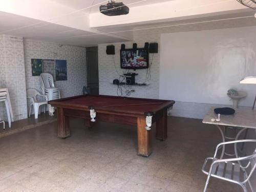 a ping pong table in a room with at Belo Horizonte - Espaço reservado para 5 pessoas in Belo Horizonte