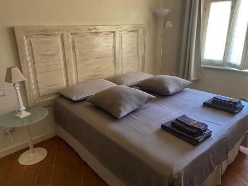 a bed in a bedroom with pillows on it at Cascina Spazio Indaco in Castagnole Monferrato