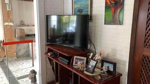 a television on a stand in a living room at Casa Itaguá in Ubatuba