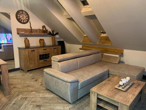 a living room with a couch and a table at Apartamenty Terminal Charzykowy in Charzykowy
