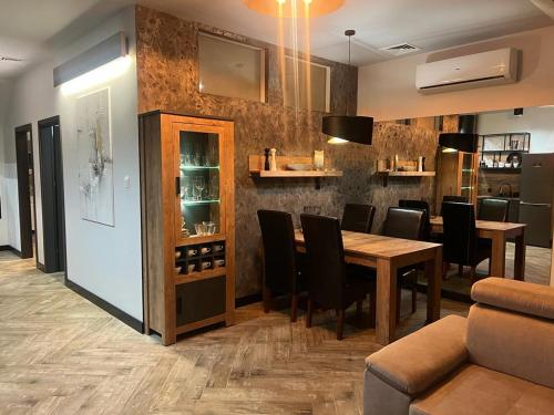 a dining room with a table and chairs at Apartamenty Terminal Charzykowy in Charzykowy