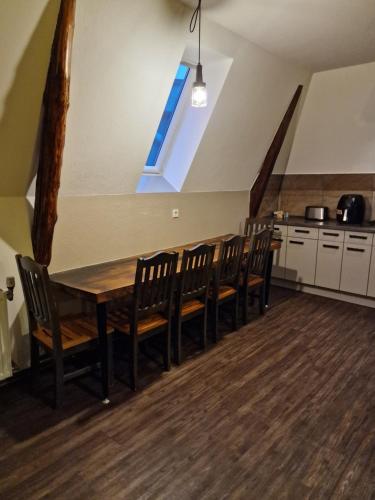 a dining room with a wooden table and chairs at VICTORY GuestHouse - Handwerker Pension in Bielefeld