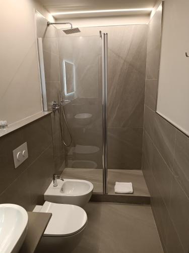 a bathroom with a shower and a toilet and a sink at Le dimore di Megollo - Free Parking in Genova