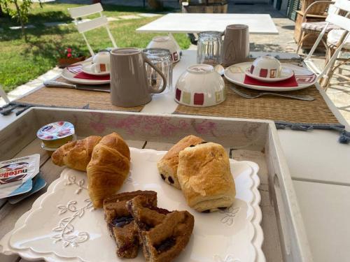 a table with a tray of pastries on it at Cascina Spazio Indaco in Castagnole Monferrato