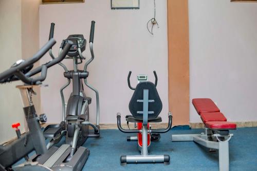 a gym with two treadmills and two exercise bikes at Tigers's apartment Hotel in Bujumbura