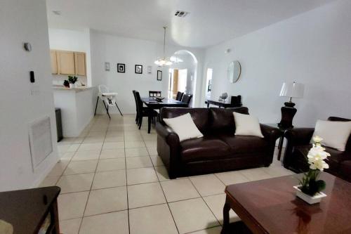 a living room with a couch and a table at Beautiful, home in a gated community in Kissimmee
