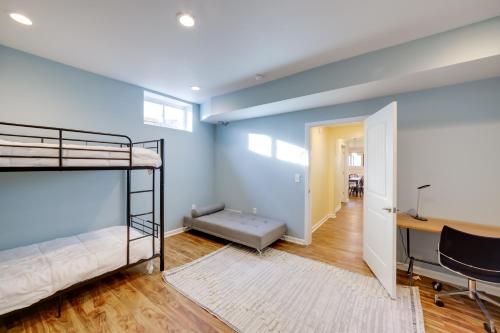 a bedroom with two bunk beds and a desk at Spacious Rockford Retreat Walk Downtown! in Rockford